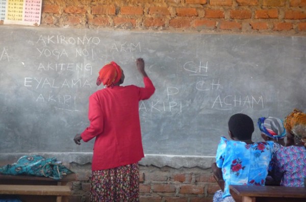 One of the beneficiaries of the functional adult literacy project practicing how to write her name